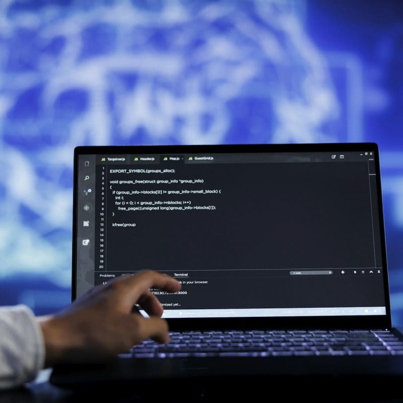Expert writes AI code on laptop