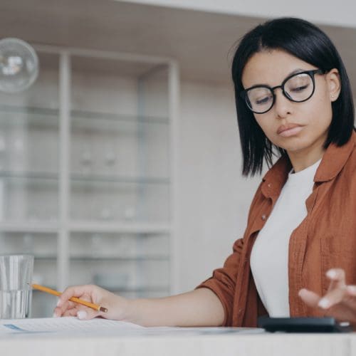 technology - svg xml charset utf 8  3Csvg 20xmlns 3D http 3A 2F 2Fwww - Technology - photo Focused female in glasses counts expenses on calculator, managing project budget, sitting at desk technology - svg xml charset utf 8  3Csvg 20xmlns 3D http 3A 2F 2Fwww - Technology